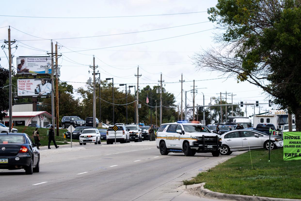 The suspect's vehicle, right, sits parked along Northeast 14th Street during a police standoff at the Budget Inn & Suites, 5220 NE 14th St., on Tuesday, September 26, 2023 in Des Moines.
