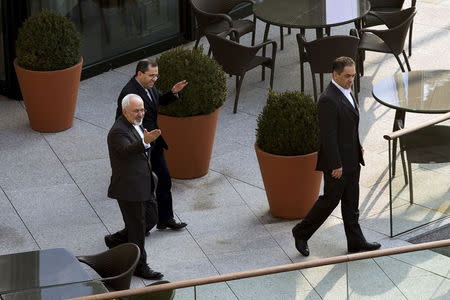 Iran's Foreign Minister Javad Zarif (L) heads out for a walk before a negotiating session with United States Secretary of State John Kerry (not pictured) over Iran's nuclear program in Lausanne March 20, 2015. REUTERS/Brian Snyder