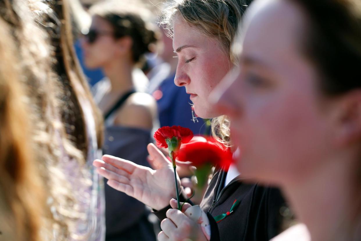 <span>People mourn the death of Laken Riley at the University of Georgia, Athens, on 26 February 2024.</span><span>Photograph: Joshua L Jones/AP</span>