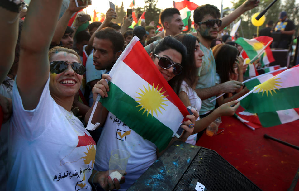 <p>Iraqi Kurds fly Kurdish flags during an event to urge people to vote in the upcoming independence referendum in Arbil, the capital of the autonomous Kurdish region of northern Iraq, Sept. 15, 2017. (Photo: Safin Hamed/AFP/Getty Images) </p>