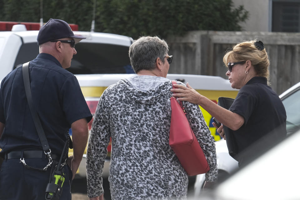 A woman comforted by member of Ventura County Fire department at U.S. Coast Guard Station Channel Islands in Oxnard, Calif. Sept. 2, 2019. (Photo: Ringo H.W. Chiu/AP)