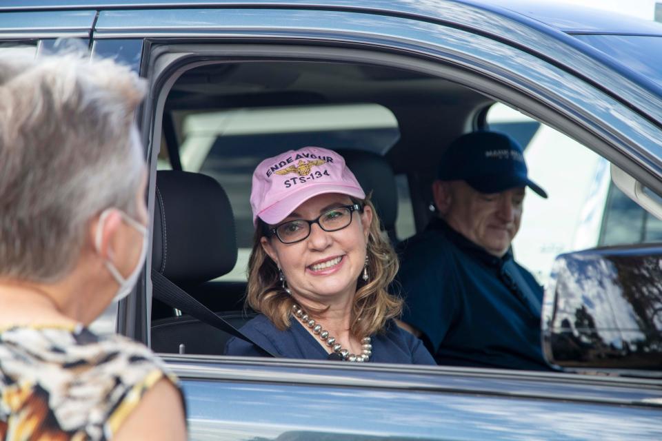 Supporters cheer Democratic Senate candidate Mark Kelly and his wife, Gabby Giffords, while they campaign in Phoenix on Oct. 25, 2020.