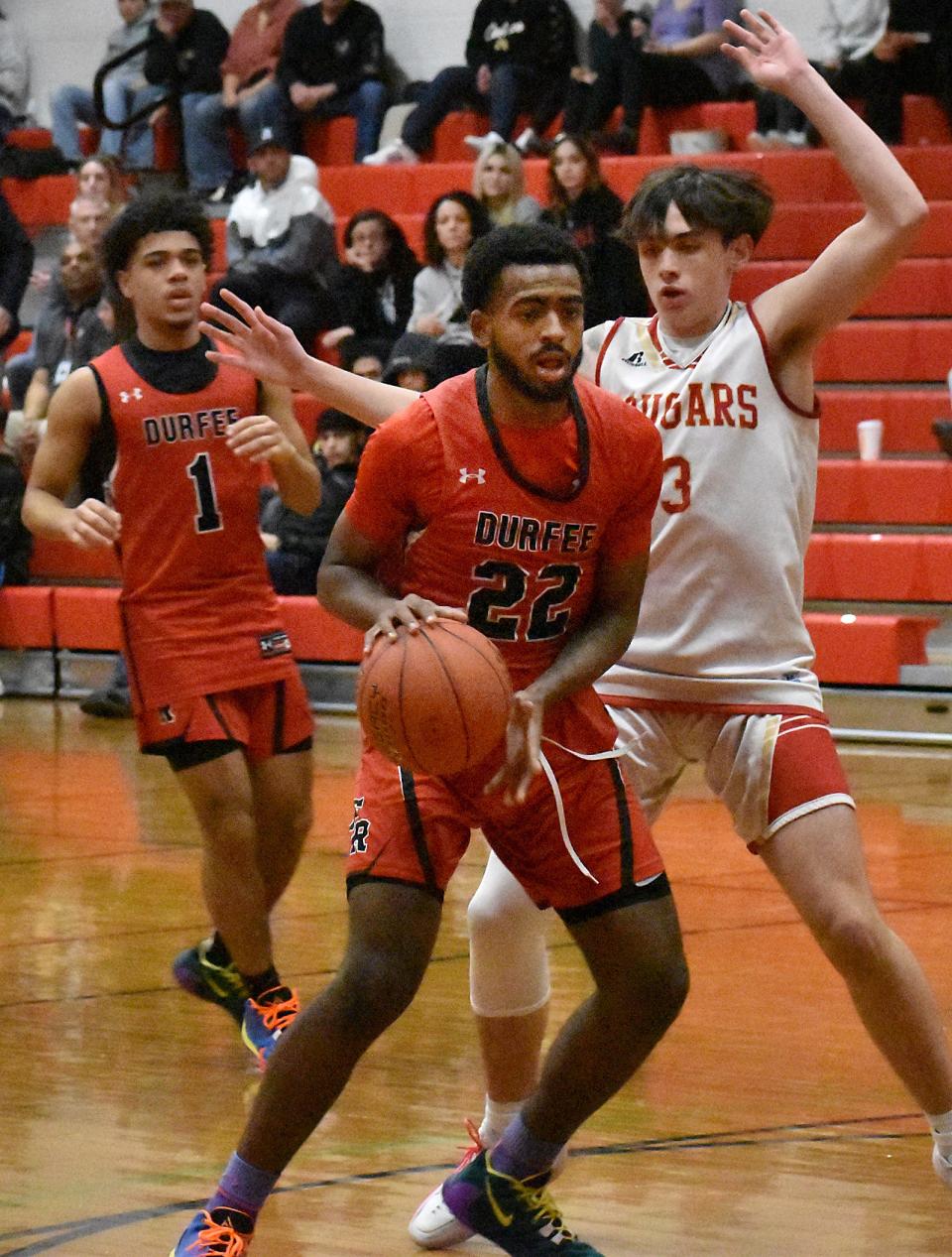 Durfee's Alexis Montilla drives on Bishop Connolly's Jayden Sousa.