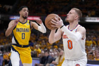 New York Knicks guard Donte DiVincenzo prepares to shoot against Indiana Pacers guard Tyrese Haliburton during the first half of Game 3 in an NBA basketball second-round playoff series Friday, May 10, 2024, in Indianapolis. (AP Photo/Michael Conroy)