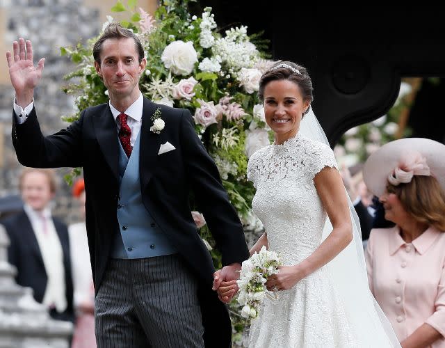 ENGLEFIELD, ENGLAND – MAY 20: Pippa Middleton and James Matthews smile for the cameras after their wedding at St Mark’s Church on May 20, 2017 in Englefield, England. Middleton, the sister of Catherine, Duchess of Cambridge married hedge fund manager James Matthews in a ceremony Saturday where her niece and nephew Prince George and Princess Charlotte was in the wedding party, along with sister Kate and princes Harry and William. (Photo by Kirsty Wigglesworth – Pool/Getty Images)