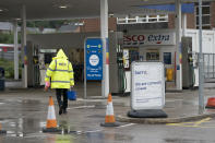 A closed petrol station in Manchester, England, Tuesday, Sept. 28, 2021. Long lines of vehicles have formed at many gas stations around Britain since Friday, causing spillover traffic jams on busy roads. (AP Photo/Jon Super)