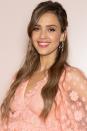 <p>Jessica Alba wears her beach waves in a relaxed look with a side part. The style is the perfect frame for a pair of statement earrings.</p>