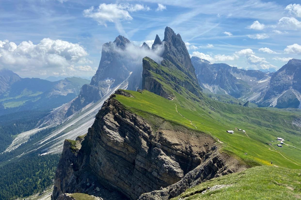 Clouds hang over the 'Seceda' Dolomites mountain, 2519 meters, near Ortisei val Gardena, (St. Ulrich in Groeden) in northern Italian province of South Tyrol, Italy, Monday, June 28, 2021.