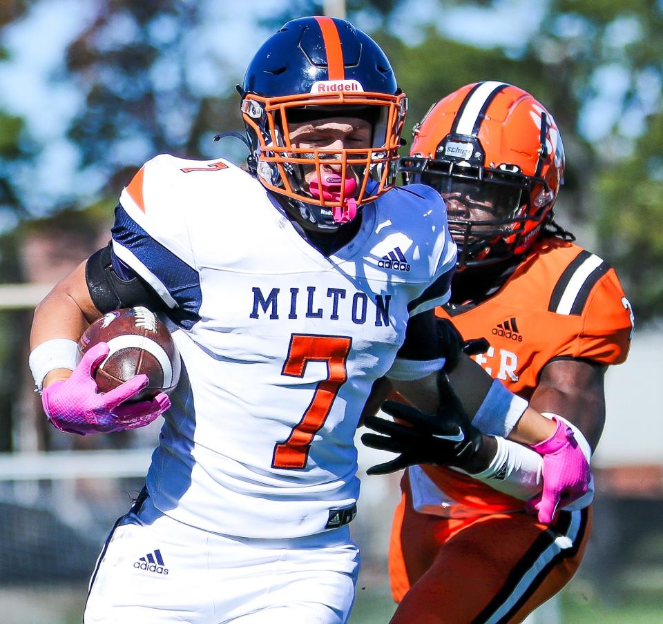 Milton Academy's Matt Childs carries the ball during a game against Thayer Academy on Saturday, Oct. 8, 2022. Milton Academy won, 41-30.
