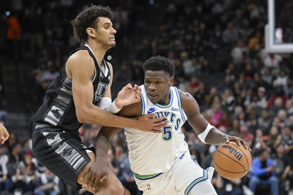 Minnesota Timberwolves' Anthony Edwards (5) drives against San Antonio Spurs' Dominick Barlow during the first half of an NBA basketball game, Saturday, Jan. 27, 2024, in San Antonio. (AP Photo/Darren Abate)