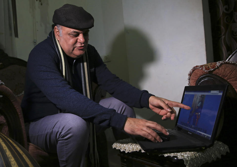 In this Tuesday, Jan. 29, 2019 photo, Palestinian actor and playwright Ali Abu Yaseen points to an image on his laptop from the 2019 Sundance Film Festival website, during an interview in his home at the Shati refugee camp in Gaza City. A new documentary called “Gaza” is hitting the screens at the prestigious Sundance Film Festival this week, providing a colorful glimpse of life in the blockaded Hamas-ruled territory. But Abu Yaseen, one of its main subjects, won’t be attending the gathering due to the very circumstances depicted in the film. (AP Photo/Adel Hana)