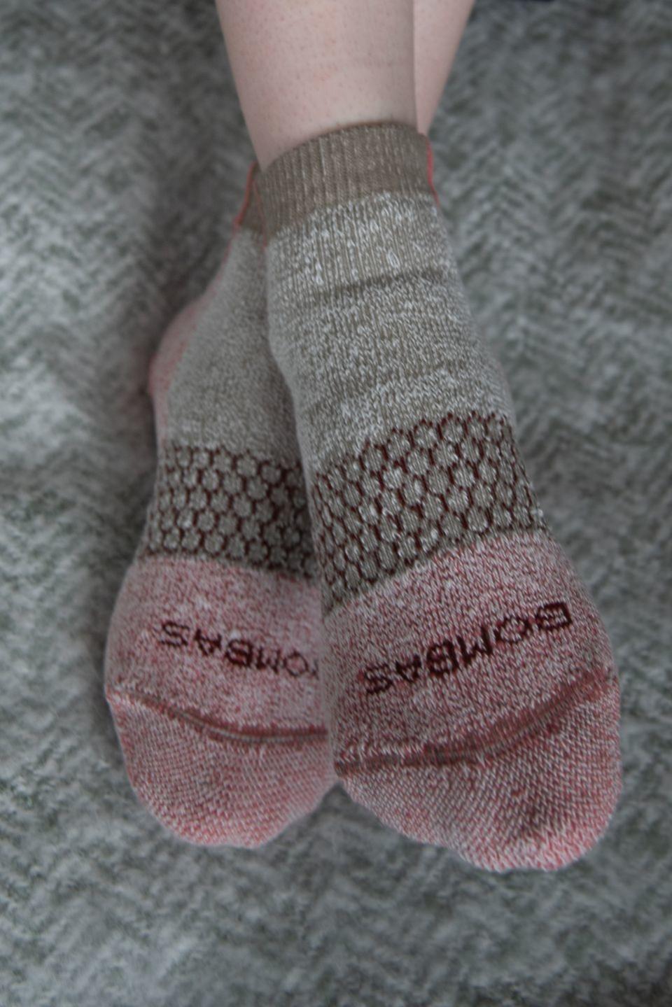 a pair of pale red and beige socks