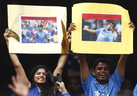 Indian supporters hold up signs before the start of the Cricket World Cup against South Africa at the Melbourne Cricket Ground (MCG) February 22, 2015. REUTERS/Brandon Malone