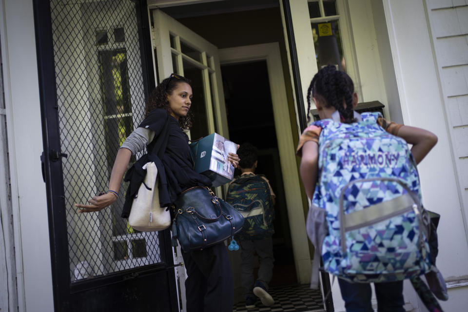 Catherine Manson carries new home nebulizer units she collected after picking up her children, Caydence Manson, and Carter Manson, from school in Hartford, Conn., on Wednesday, May 25, 2022. A 2018 study noted that "evidence has been building for 100 years that toxic exposures in the environment can cause and aggravate disease in children" – specifically asthma, lead poisoning and obesity, three chronic conditions that have an outsized impact on Black children, including Caydence and Carter. (AP Photo/Wong Maye-E)