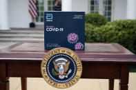 A 5-minute test kit for COVID-19 developed by Abbott Laboratories sits on a table ahead of a briefing by President Donald Trump about the coronavirus in the Rose Garden of the White House, Monday, March 30, 2020, in Washington. (AP Photo/Alex Brandon)
