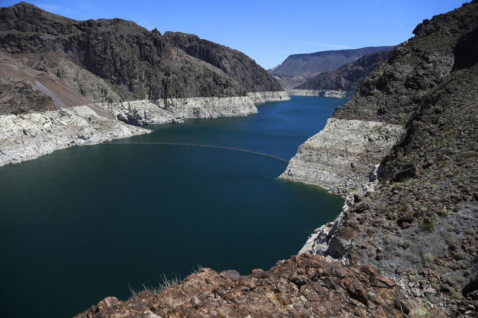 FILE - This May 31, 2018 file photo shows the reduced water level of Lake Mead behind Hoover Dam in Arizona. California and Arizona have missed a federal deadline for seven Western states to wrap up work on a plan to ensure the drought-stricken Colorado River can deliver water to millions of people who depend on it. (AP Photo/Ross D. Franklin, File)