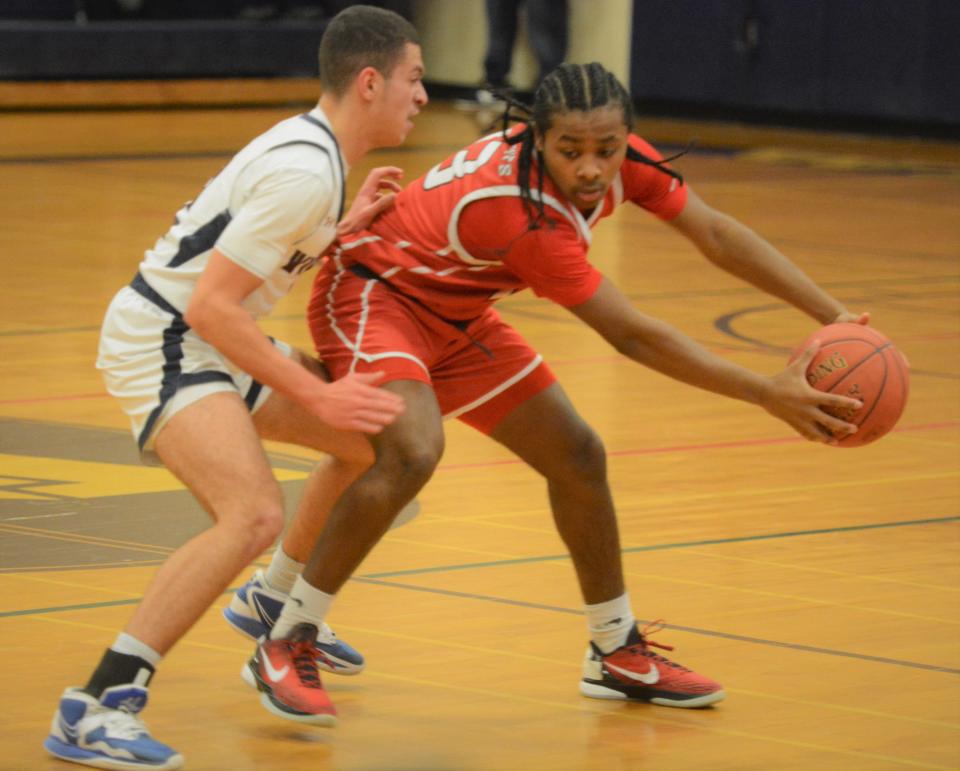 NFA freshman Jamir Hall keeps the ball away from Windham defender Jack Jenkins Jr. on Thursday in Willimantic.