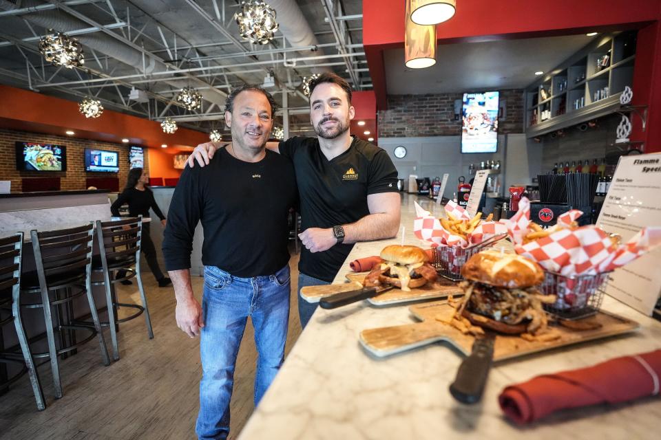 Henri Najem, owner of Flamme Burger LLC (left) and Nick Najem, owner of Flamme Burger (right) pose together at their restaurant at 8487 Union Chapel Road.