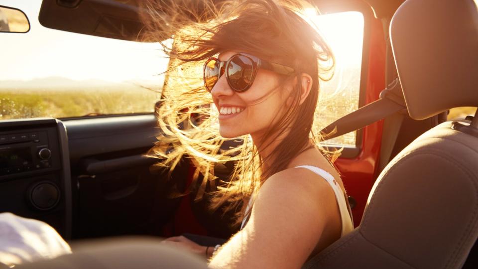 woman in car hair blowing in wind