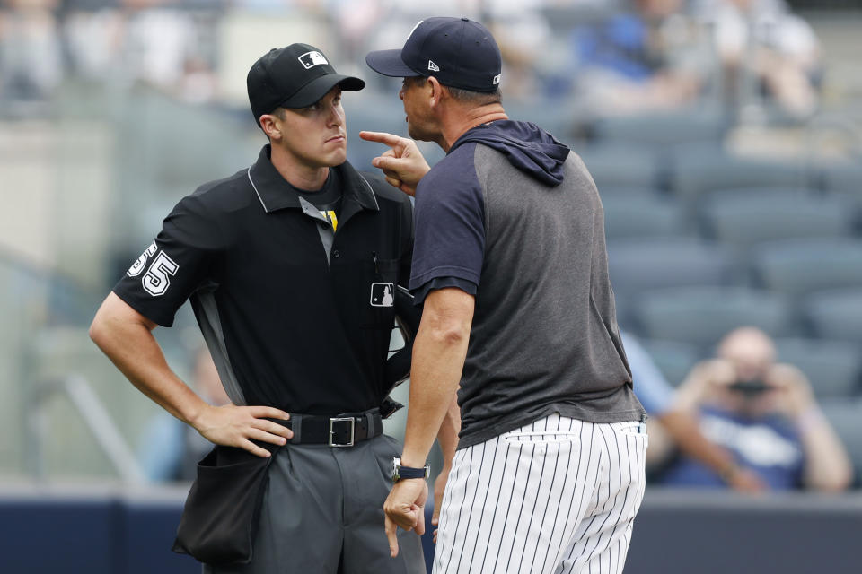 New York Yankees' manager Aaron Boone yells at home plate umpire Brennan Miller during the second inning of the first game of a baseball doubleheader against the Tampa Bay Rays' Thursday, July 18, 2019, in New York. (AP Photo/Kathy Willens)