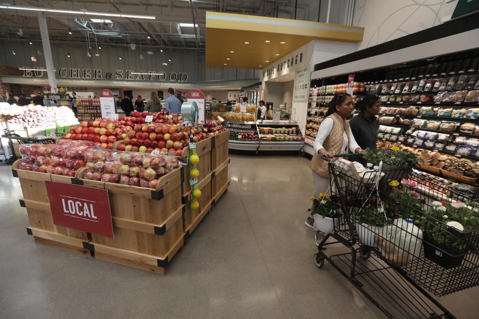 Seema Sanasie of Gates and her wife, Danni,  shop at Whole Foods Market. They said they saw it being built and came to see what the store offered.