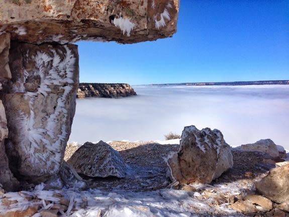 Fog filling the Grand Canyon. Noticed the ice crystals on the limestone in the foreground.