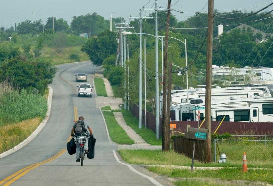 A cyclist rides along the 7800 block of Blue Goose Road. Some residents of the area said they didn't vote in last week's disannexation election because they didn't understand the proposition or its effects.