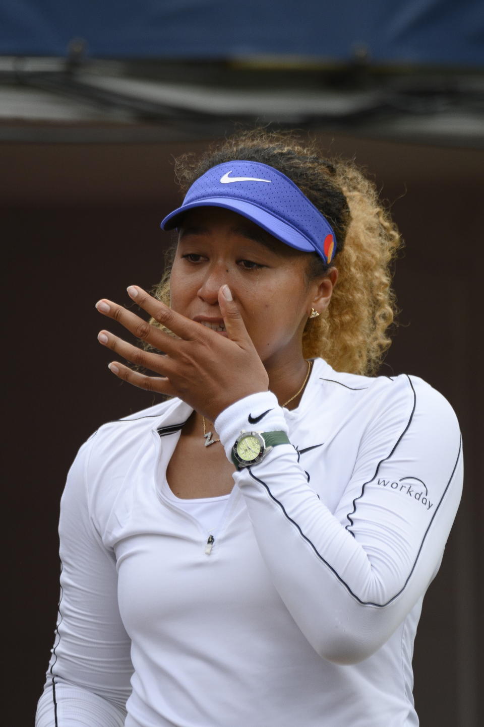 Naomi Osaka wipes a tear after retiring early from a match against Kaia Kanepi of Estonia, during the National Bank Open tennis tournament in Toronto, on Tuesday, Aug. 9, 2022. (Christopher Katsarov/The Canadian Press via AP)
