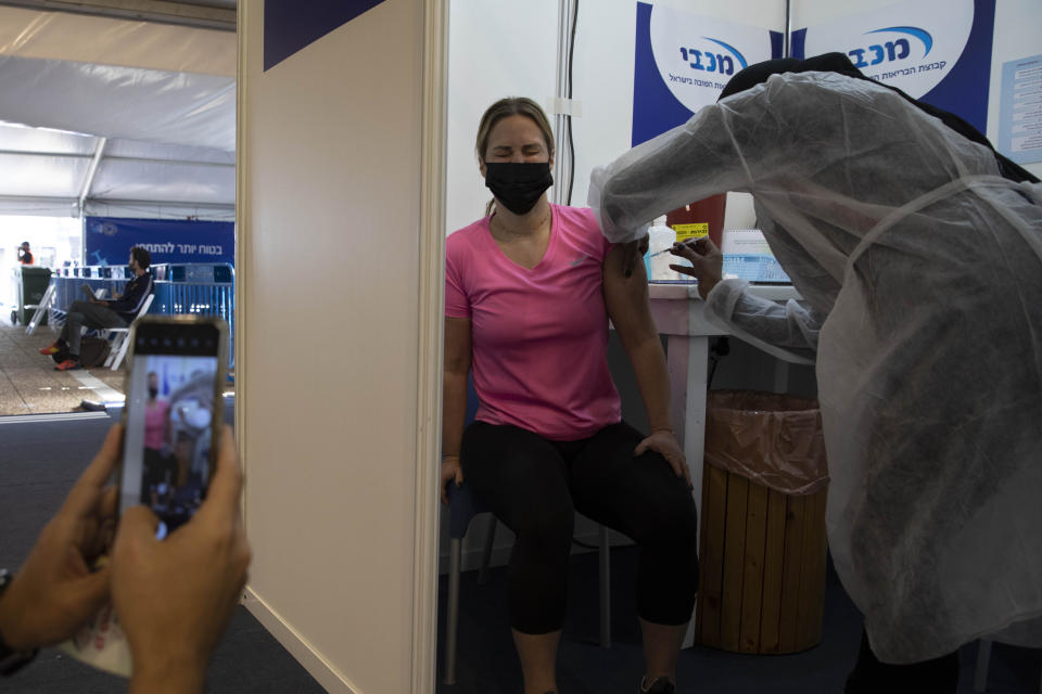 An Israeli woman receives a Pfizer-BioNTech coronavirus vaccine at a COVID-19 vaccination center in Tel Aviv, Israel on Feb. 2, 2021. (Sebastian Scheiner/AP)