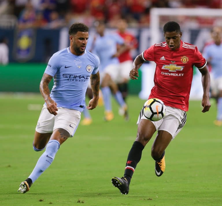 Manchester United's Marcus Rashford (R) fights for the ball Kyle Walker of Manchester City, at NRG Stadium in Houston, Texas, on July 20, 2017