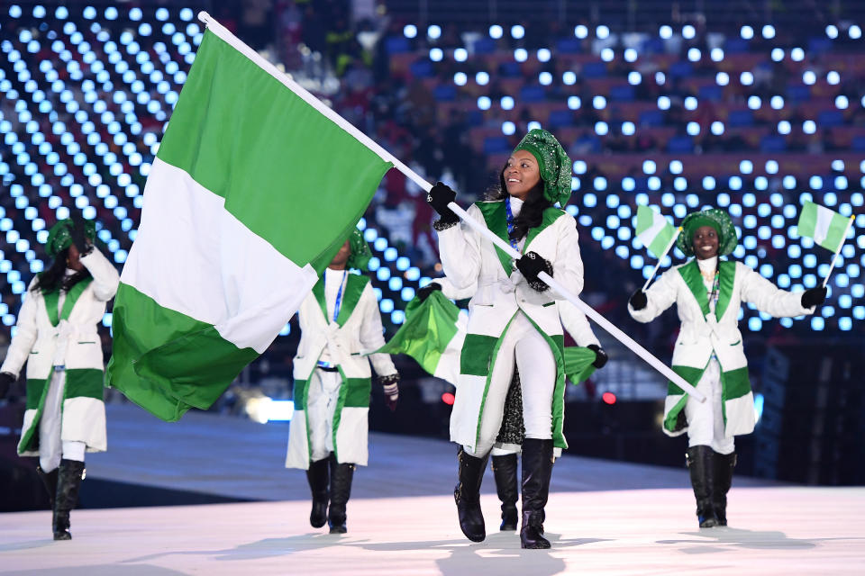 Team Nigeria wears winter-white and green coats with embellished geles, or headscarves. (Photo: Getty Images)