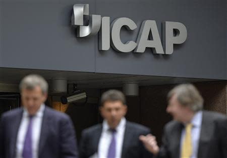 People walk past an ICAP office in the City of London September 25, 2013. REUTERS/Toby Melville