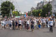 People hold posters that read: "Freedom for Khabarovsk region's governor Sergei Furgal" during an unsanctioned protest in support of Sergei Furgal, the governor of the Khabarovsk region, in Khabarovsk, 6100 kilometers (3800 miles) east of Moscow, Russia, Saturday, July 18, 2020. Tens of thousands of people in the Russian Far East city of Khabarovsk took to the streets on Saturday, protesting the arrest of the region's governor on charges of involvement in multiple murders. Local media estimated the rally in the city attracted from 15,000 to 50,000 people. (AP Photo/Igor Volkov)