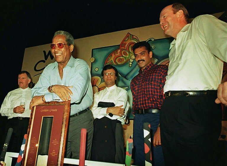 Cricketing greats Ian Chappell (L), Sir Gary Sobers (leaning on plaque), Asif Iqbal (centre back), Ravi Shastri (2nd R) and Tony Greig at a cricket memorabila auction at a hotel in south Bombay on May 16, 1997. Flamboyant former England cricket captain and television commentator Greig died of a heart attack on Saturday at the age of 66, as he battled lung cancer