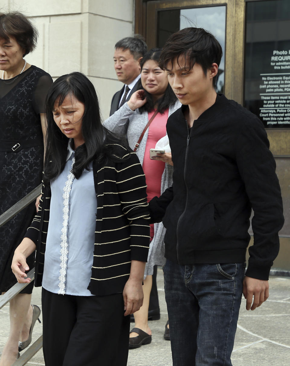 Lifeng Ye, left, and her son Zhengyang Zhang, right, the mother and brother of slain University of Illinois scholar Yingying Zhang, leave the U.S. Courthouse in Peoria, Ill., on Monday, June 24, 2019, after a federal jury found Brendt Christensen guilty of kidnapping and murdering Yingying Zhang. (Terrence Antonio James/Chicago Tribune via AP)