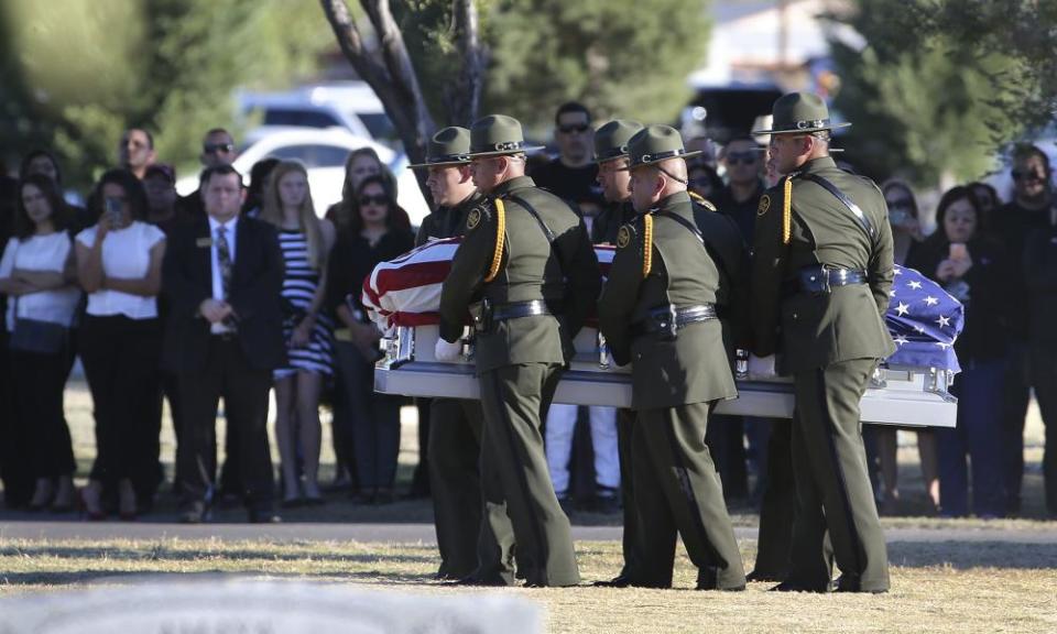 Border patrol pallbearers carry agent Rogelio Martinez to a graveside service at Restlawn Cemetery on 25 November in El Paso, Texas.