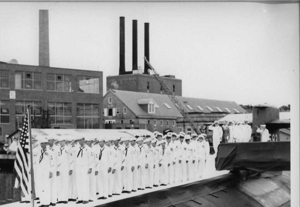 Officers and crew salute the colors atop USS Thresher (SSN 593) on Aug. 3, 1961, outside Building #5 at Portsmouth Naval Shipyard. Thresher was lost at sea on April 10, 1963. All 129 men on board died.