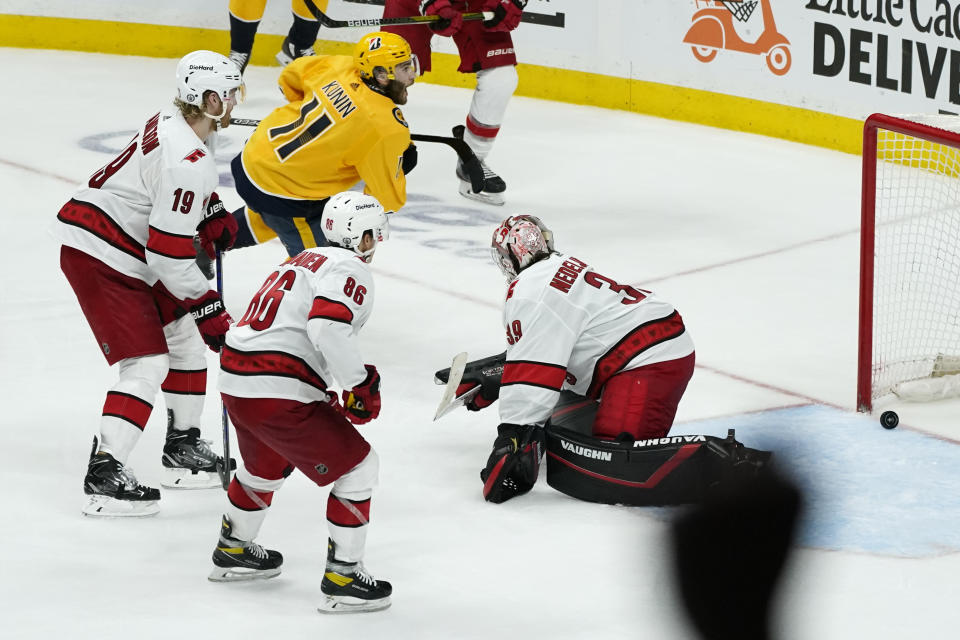 Nashville Predators center Luke Kunin (11) scores the winning goal past Carolina Hurricanes goaltender Alex Nedeljkovic (39) during the second overtime in Game 4 of an NHL hockey Stanley Cup first-round playoff series Sunday, May 23, 2021, in Nashville, Tenn. The Predators won 4-3 to even the series 2-2. (AP Photo/Mark Humphrey)