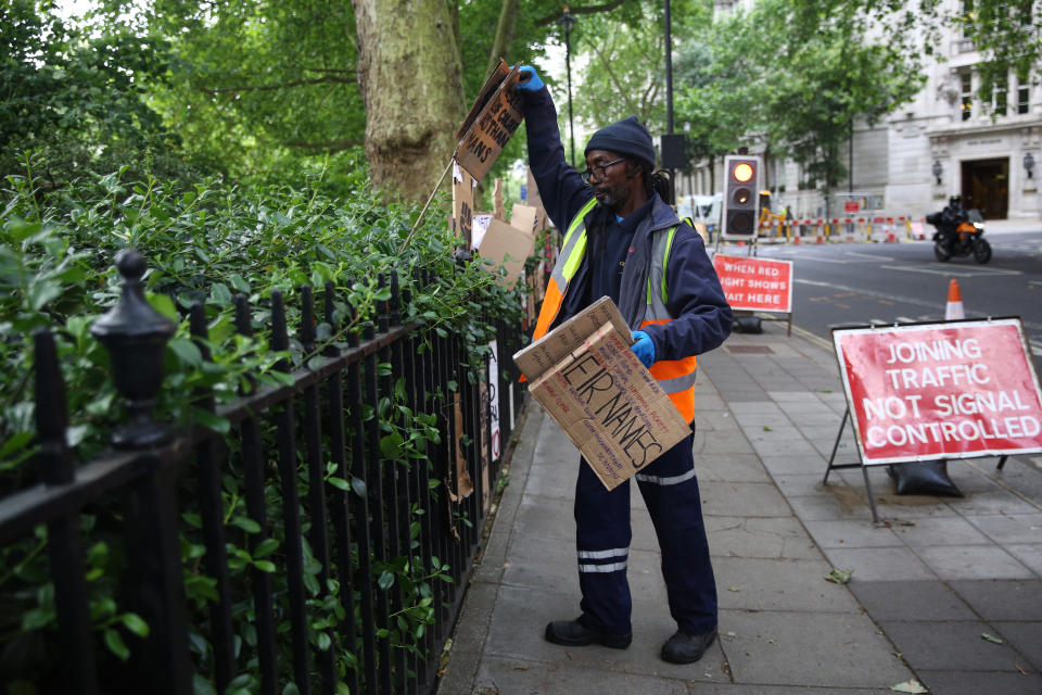 A worker collects discarded placards from Victoria Tower Gardens in Westminster, London, following a Black Lives Matter protest at the weekend. A raft of protests across the UK were sparked by the death of George Floyd, who was killed on May 25 while in police custody in the US city of Minneapolis.