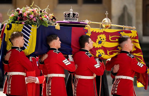 LONDON, ENGLAND - SEPTEMBER 19: The coffin of Queen Elizabeth II with the Imperial State Crown resting on top is carried by the Bearer Party as it departs Westminster Abbey during the State Funeral of Queen Elizabeth II on September 19, 2022 in London, England. Elizabeth Alexandra Mary Windsor was born in Bruton Street, Mayfair, London on 21 April 1926. She married Prince Philip in 1947 and ascended the throne of the United Kingdom and Commonwealth on 6 February 1952 after the death of her Father, King George VI. Queen Elizabeth II died at Balmoral Castle in Scotland on September 8, 2022, and is succeeded by her eldest son, King Charles III.  (Photo by Christopher Furlong/Getty Images)