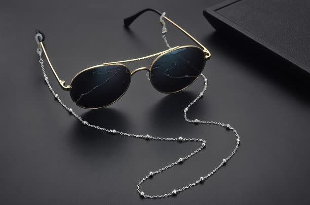 And a delicate eyeglass chain
