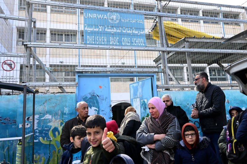 Palestinian refugees stand at the entrance to the UN Relief and Works Agency for Palestinian Refugees school in the Dheisheh Refugee Camp near Bethlehem, West Bank, on Tuesday. Photo by Debbie Hill/ UPI