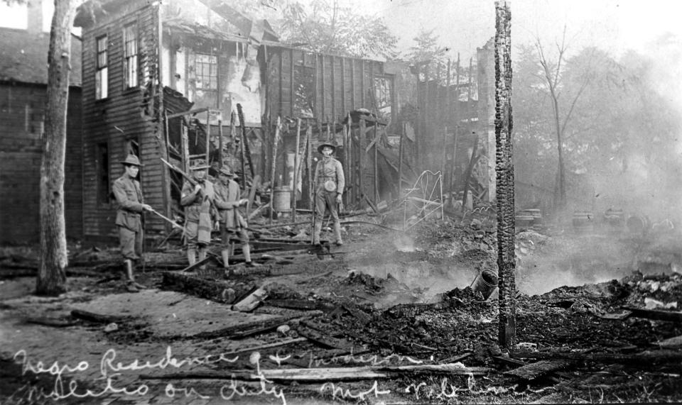 Illinois National Guard soldiers on duty among burned out residences. (Sangamon Valley Collection / Lincoln Library)