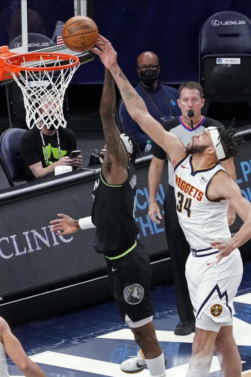 Denver Nuggets' JaVale McGee (34) knocks away a layup by Minnesota Timberwolves' Jarred Vanderbilt during the first half of an NBA basketball game Thursday, May 13, 2021, in Minneapolis. (AP Photo/Jim Mone)