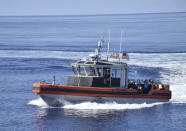 In this Tuesday, May 14, 2019, photo provided by the Philippine Coast Guard, the American Coast Guard conducts joint search and rescue exercises with their Philippine counterparts off the South China Sea west of the Philippines. Captain John Driscoll, commanding officer of the U.S. Coast Guard National Security Cutter Bertholf (WMSL 750), told reporters Wednesday, May 15, 2019, two Chinese Coast Guard ships were spotted off the South China Sea while they were conducting the joint exercise with Philippine Coast Guard. (Philippine Coast Guard Via AP)