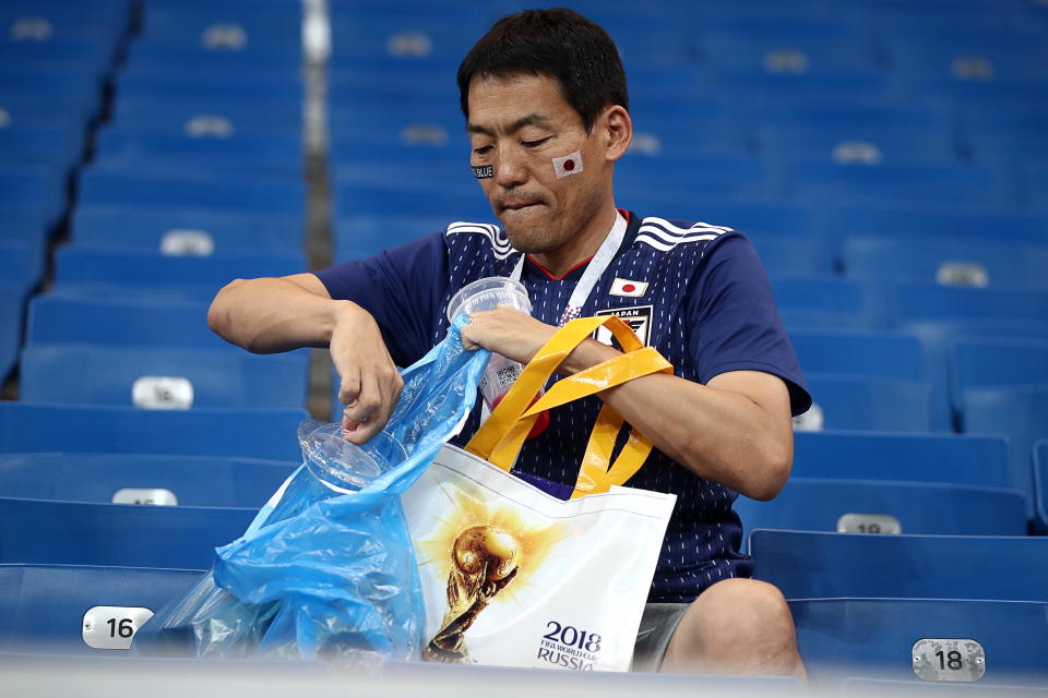 <p>Japan’s supporter picking up litter after their 2018 FIFA World Cup Round of 16 football match against Belgium at Rostov Arena Stadium. Team Belgium won the game 3:2. Valery Sharifulin/TASS (Photo by Valery Sharifulin\TASS via Getty Images) </p>