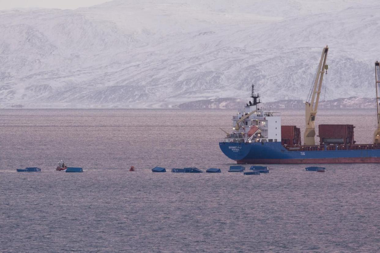 Twenty shipping containers and some freight fell off a sealift barge near the Iqaluit port, the government of Nunavut said on Friday afternoon. (Jason Harasimo - image credit)