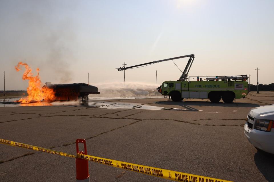 Firefighters douse a blaze that was treated as if it were a flaming jetliner during an emergency-response drill Saturday at T.F. Green Airport.