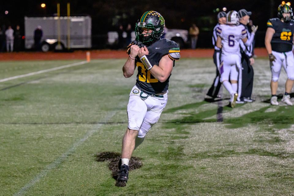 Rock Bridge's Cooper Myers (32) celebrates in the end zone after scoring a Bruins' touchdown during the Class 6 District 4 championship game at Rock Bridge High School on Nov. 10, 2023, in Columbia, Mo.