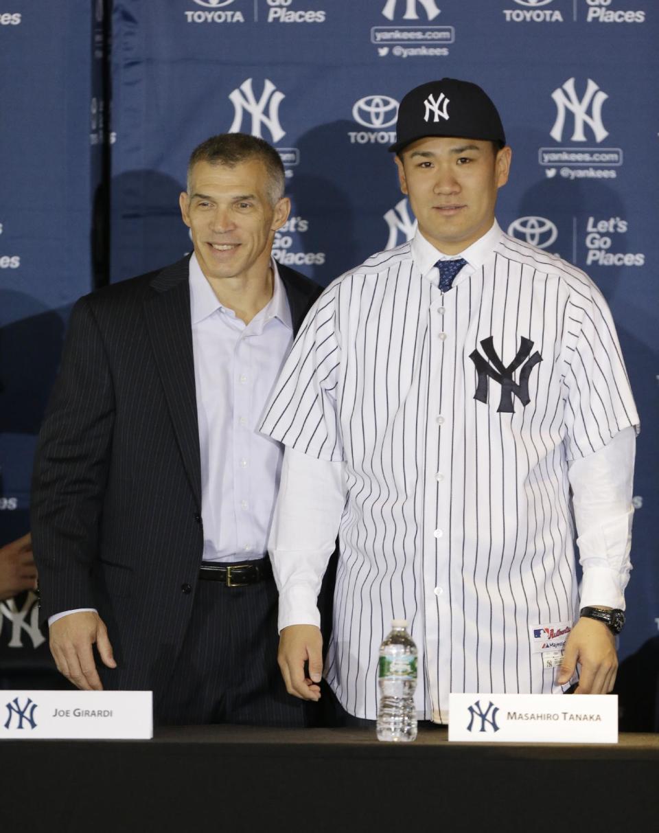 New York Yankees pitcher Masahiro Tanaka, of Japan, poses for photographs with manager Joe Girardi during a news conference at Yankee Stadium Tuesday, Feb. 11, 2014, in New York. (AP Photo/Frank Franklin II)